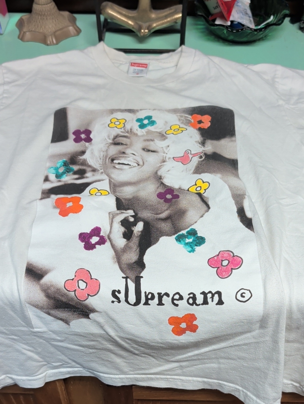 Supreme White Graphic Tee with Multicolor Floral Accents